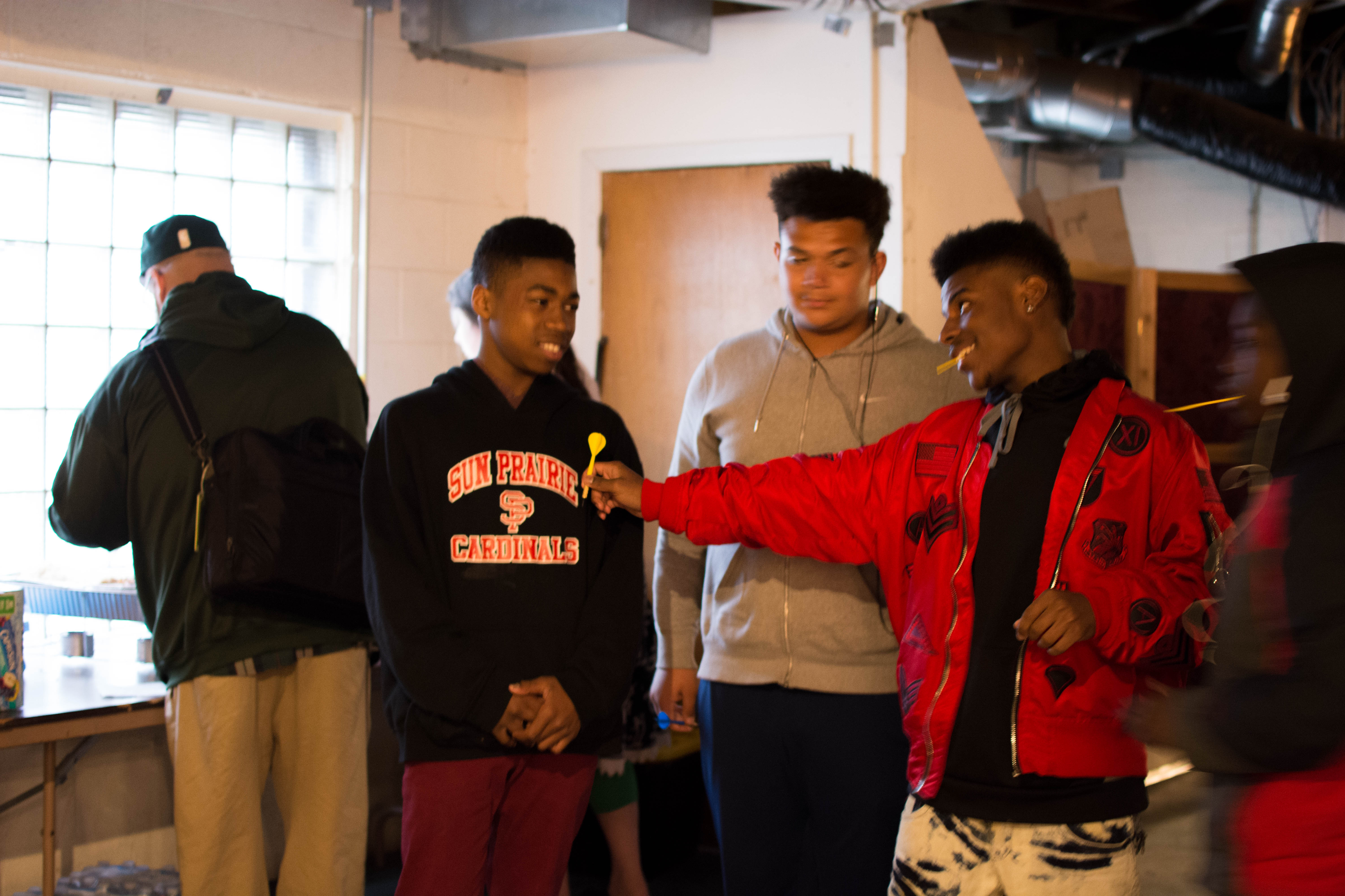 picture of teens playing darts at Air It Out teen art exhibition party