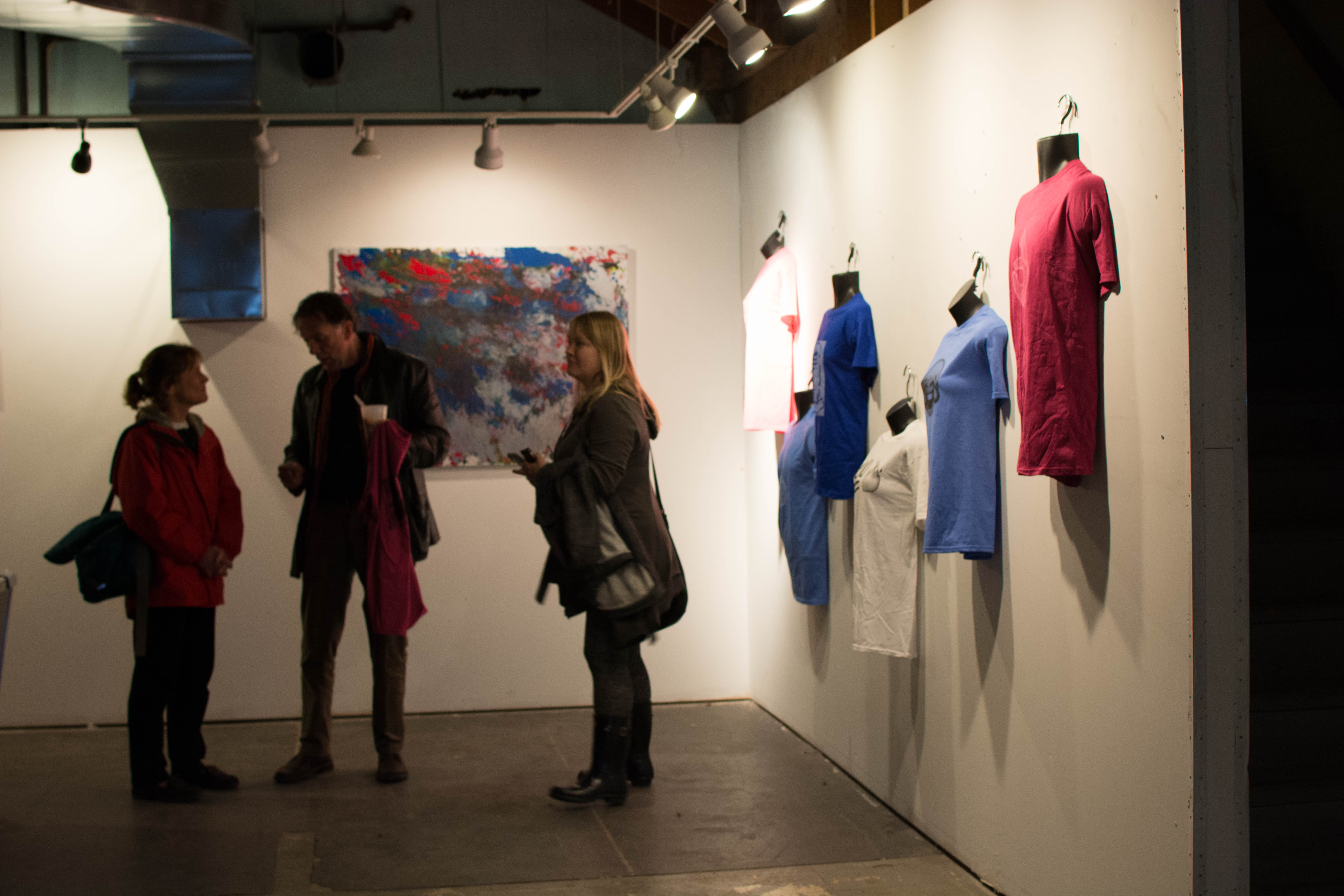 picture of people enjoying the party next to screen print exhibit