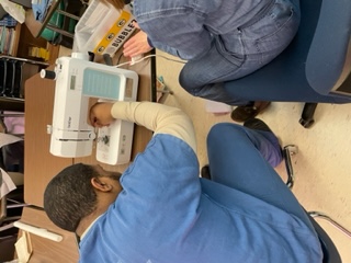 Sewing Metro Panthers high school graduation gowns at Dane County Jail