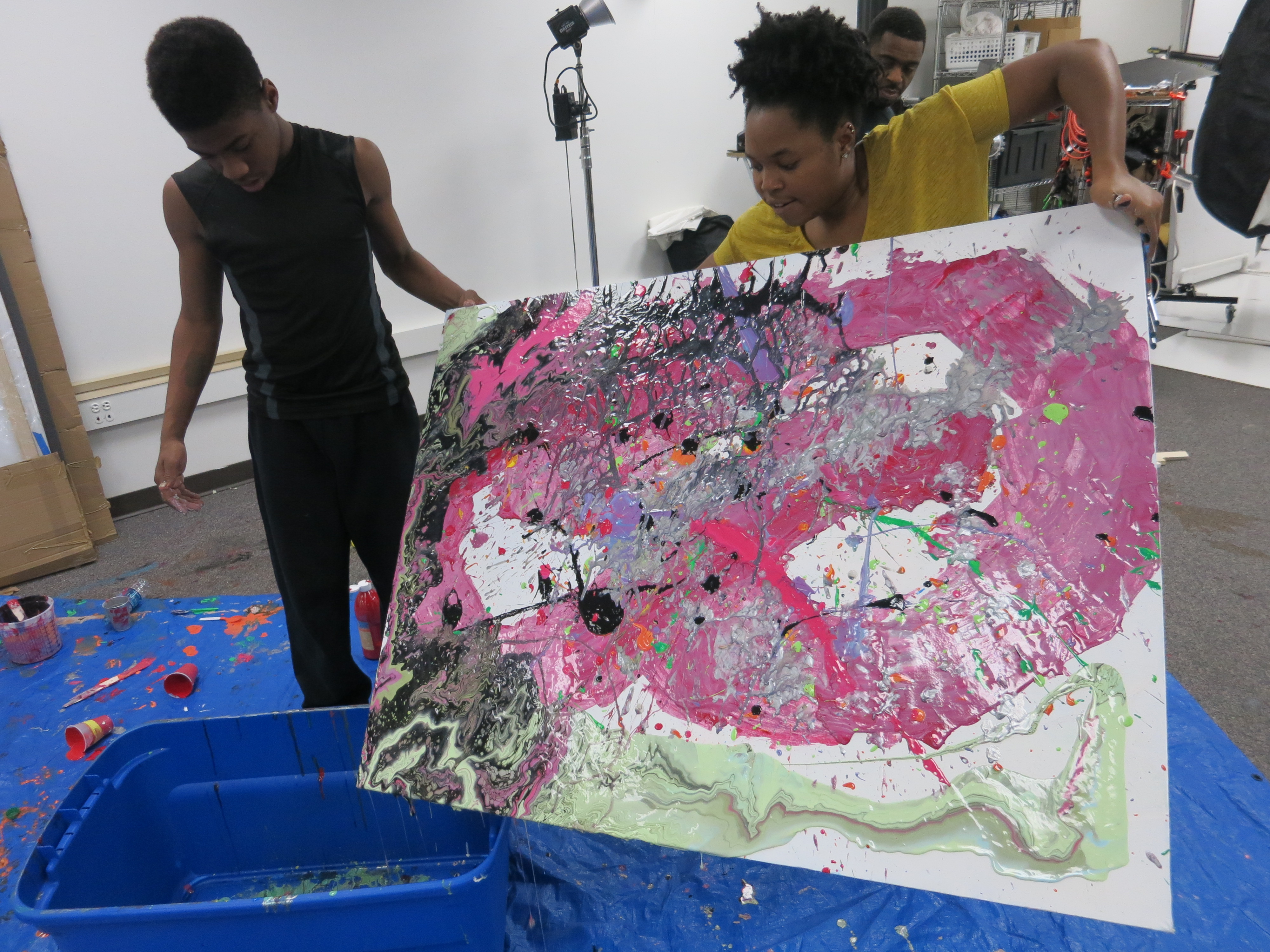 picture of teens creating drip paintings during Air It Out semester of art